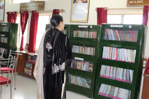 Chairperson FWO in the library watches some collection of books